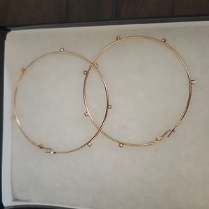 Gold hoops with crystal gems around them